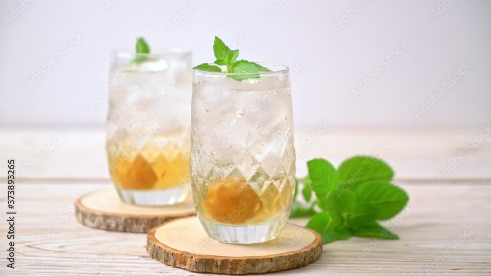 iced plum juice with soda and peppermint on wood table - refreshment drink iced plum juice with soda and peppermint on wood table - refreshment drink