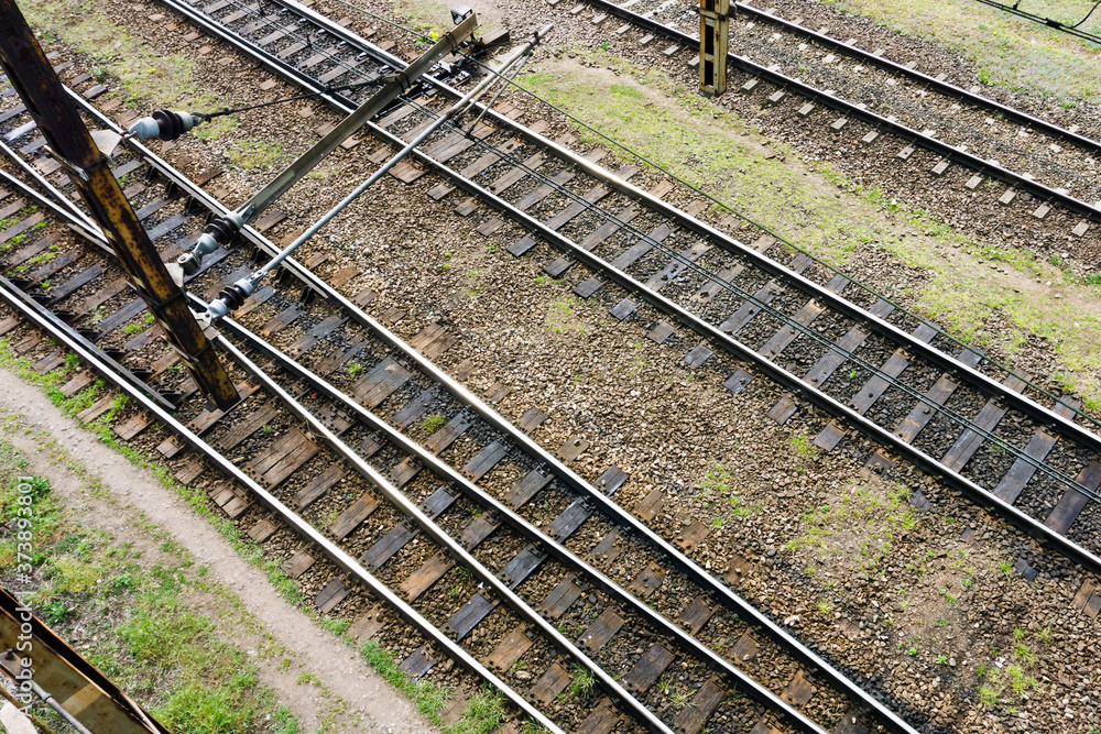 Railway top view background. Train transport industry. Rail track texture. Good and cheap way of transportation for cargo. Old railroad wooden tie. Track ballast gravel made of crushed stone. Railway top view background. Train transport industry. Rail track texture. Good and cheap way of transportation for cargo. Old railroad wooden tie. Track ballast gravel made of crushed stone.