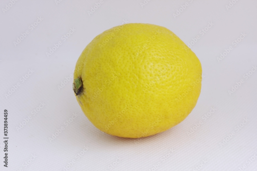 One lemon, isolated on a white background. Tropical fruit. Whole lemon. Flat lay. Vitamin C. Lemon is yellow. Copy space for text