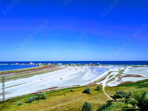 Natural landscape near the sea. The sea and the estuary are separated by a narrow strip of land. photo