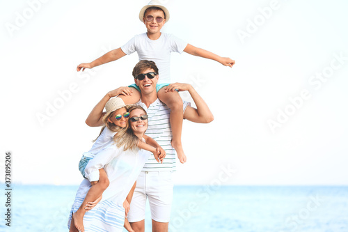 Happy family on sea beach a...