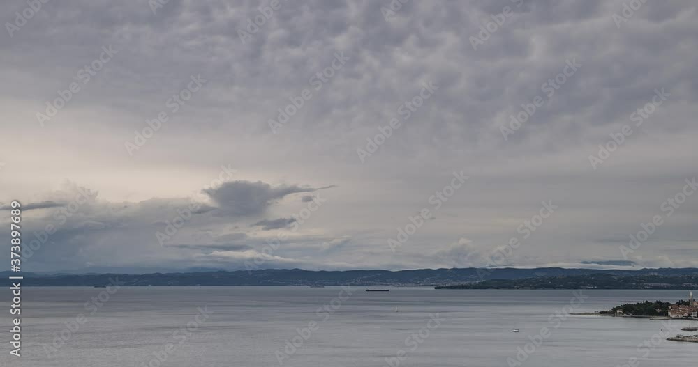 Time lapse of storm cloud moving over gulf of Trieste. Elevated aerial view of traffic in Adriatic Sea waters. Bad weather at the sea. Wide shot, right truck, parallel moving Time lapse of storm cloud moving over gulf of Trieste. Elevated aerial view of traffic in Adriatic Sea waters. Bad weather at the sea. Wide shot, right truck, parallel moving