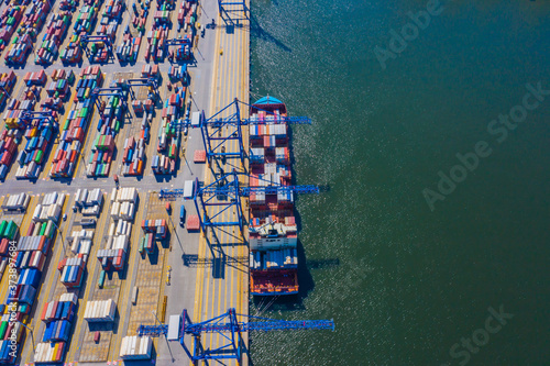 Aerial top view container cargo ship waiting for loading, import export business logistic and transportation by ship in open sea.