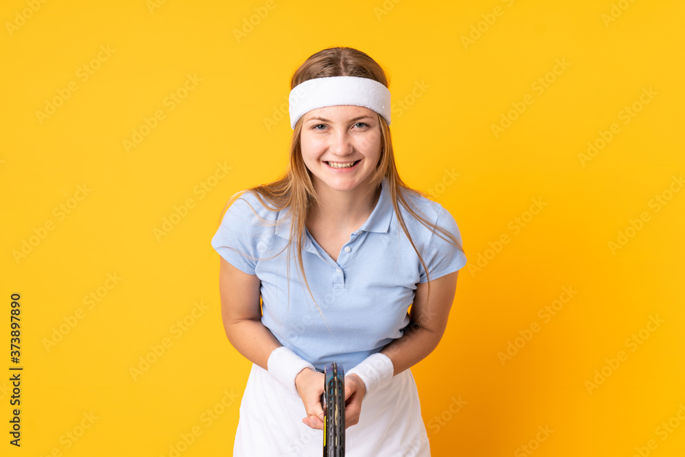 Teenager Ukrainian girl tennis player isolated on yellow background Teenager Ukrainian girl tennis player isolated on yellow background