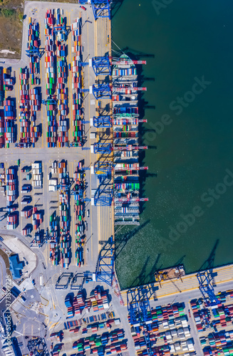 Container ship from sea port working for delivery containers shipment and container warehouse background. Suitable use for transport or import export to global logistics concept.