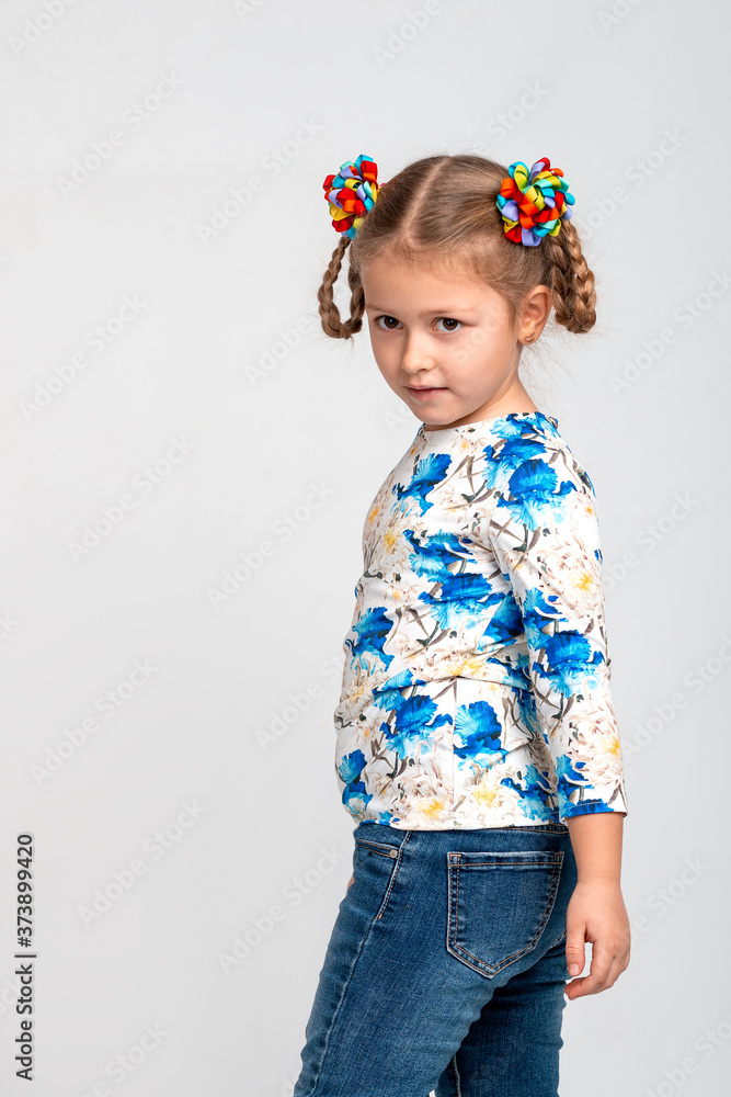 Half length profile portrait of a little girl with two pigtails and color bows, isolated Half length profile portrait of a little girl with two pigtails and color bows, isolated