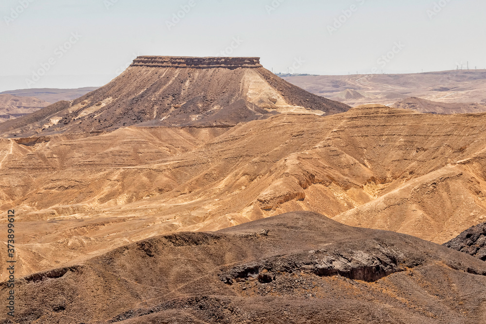 Fototapeta premium View of the Ramon crater colorful mountains with traces of geological events. Negev desert. Israel