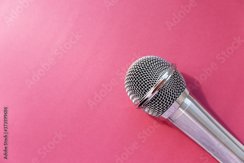 The microphone is on a bright pink background. The view from the top.