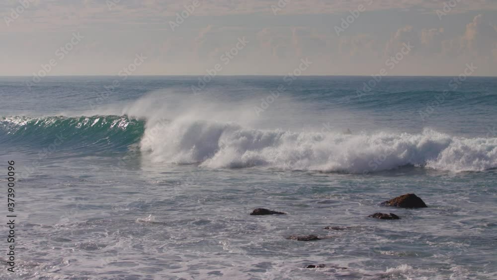 Surfers at Manly Beach in the early morning with the sun in the background on a beautiful blue clear day Sydney Australia Surfers at Manly Beach in the early morning with the sun in the background on a beautiful blue clear day Sydney Australia
