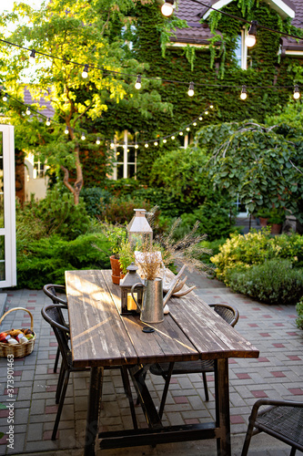 table for lunch in garden of country house  photo