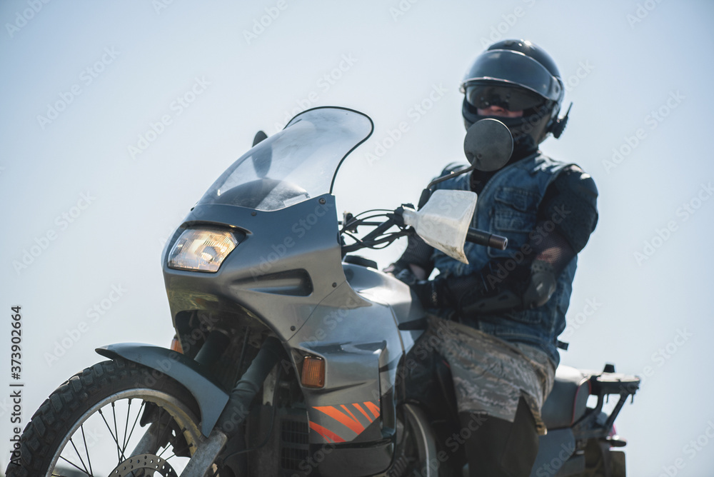 Motor biker on the motorbike outdoors. Motor biker on the motorbike outdoors.