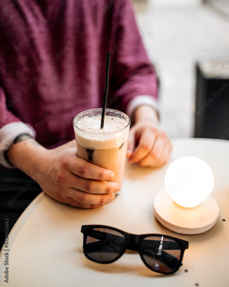 Man drinking latte coffee sitting in cafe Man drinking latte coffee sitting in cafe