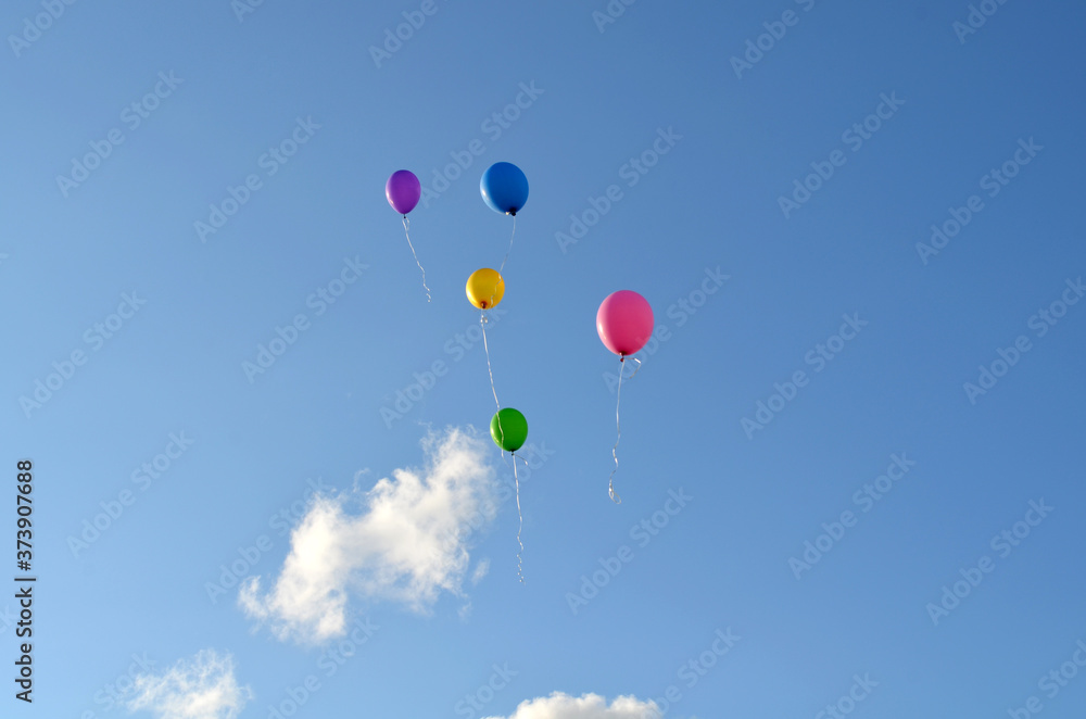 Five multicolored balloons in the blue sky. Balloons in the sky. Holiday Five multicolored balloons in the blue sky. Balloons in the sky. Holiday