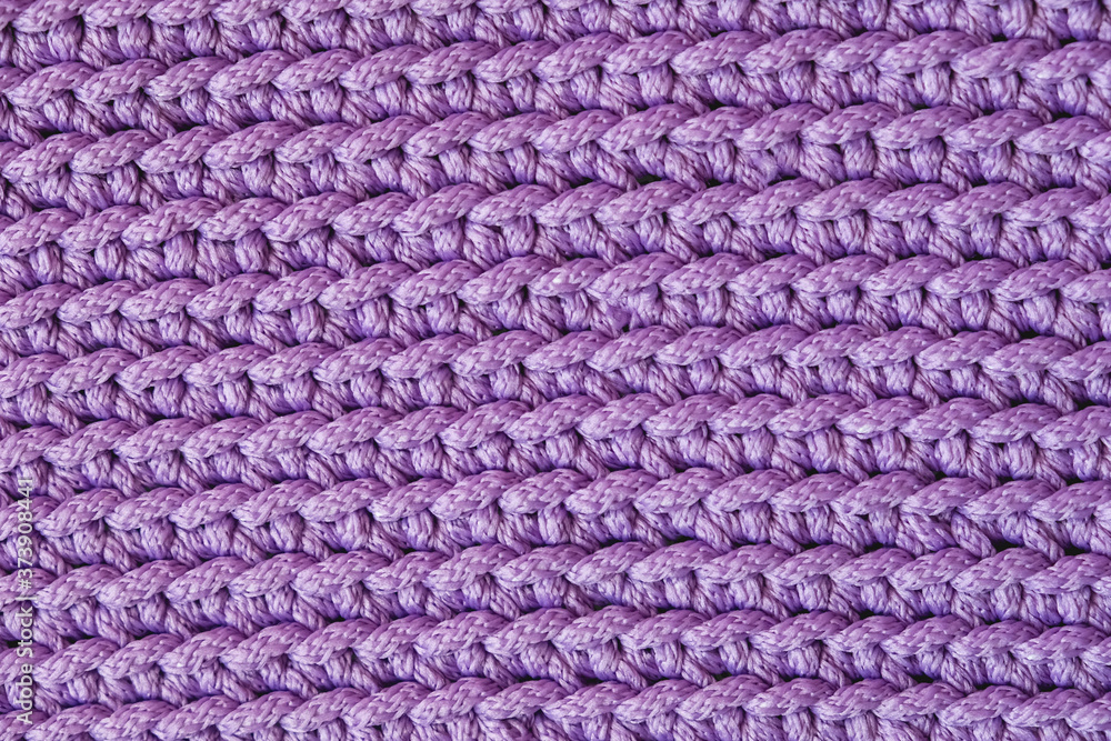 Violet knitted fabric texture background. Top view. Copy, empty space for text