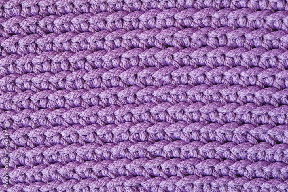 Violet knitted fabric texture background. Top view. Copy, empty space for text Violet knitted fabric texture background. Top view. Copy, empty space for text