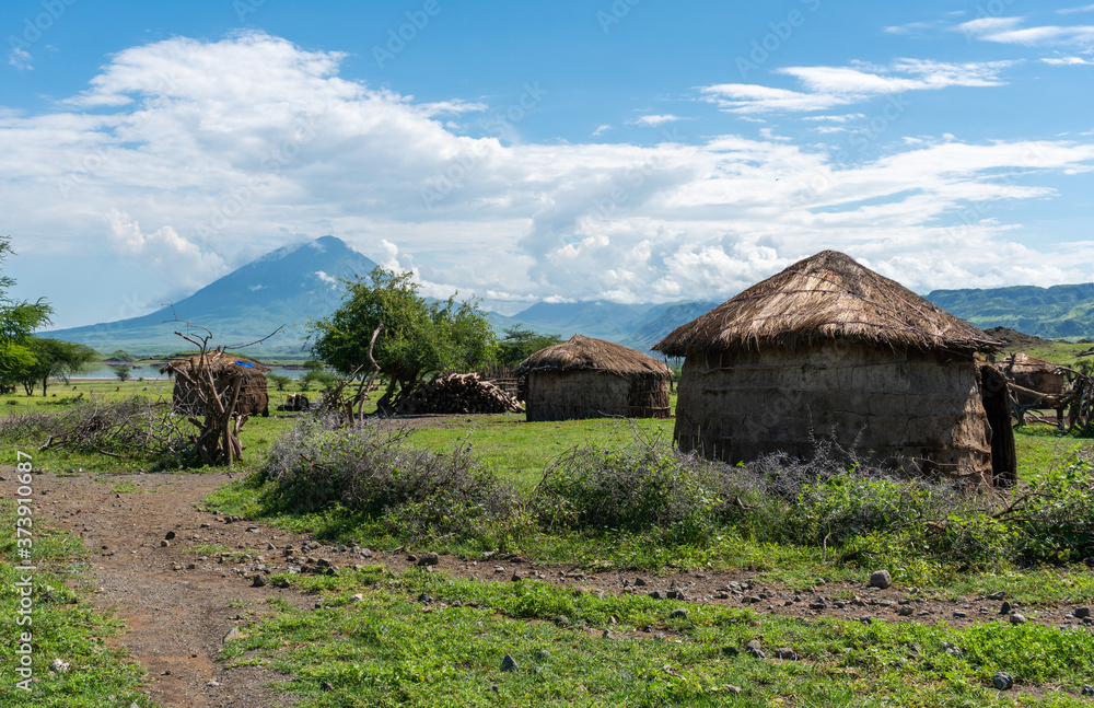 Traditional Maasai Village with Clay Round Huts in Engare Sero area near Lake Natron and Ol Doinyo Lengai volcano in Tanzania, Africa