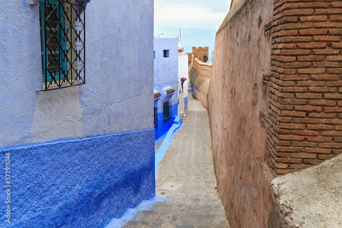 View of the old walls of Medina quarter in Chefchaouen, Morocco. The city, also known as Chaouen is noted for its buildings in shades of blue and that makes Chefchaouen very attractive to visitors. © Renar