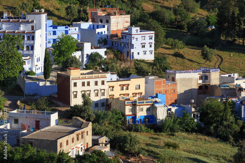 View of the residential buildings in suburb of Chefchaouen, Morocco. The city, also known as Chaouen is noted for its buildings in shades of blue and that makes Chefchaouen very attractive to visitors