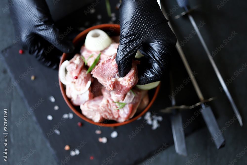 Selective focus. The chef stringed meat for barbecue on a skewer. Raw kebab. Cooking kebabs. Selective focus. The chef stringed meat for barbecue on a skewer. Raw kebab. Cooking kebabs.