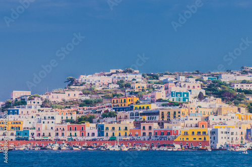 Fototapeta Naklejka Na Ścianę i Meble -  Ponza Island, Italy - 27 July 2019: View of little harbor of Ponza island in the summer season with typical colored houses and boats. Ponza, Italy
