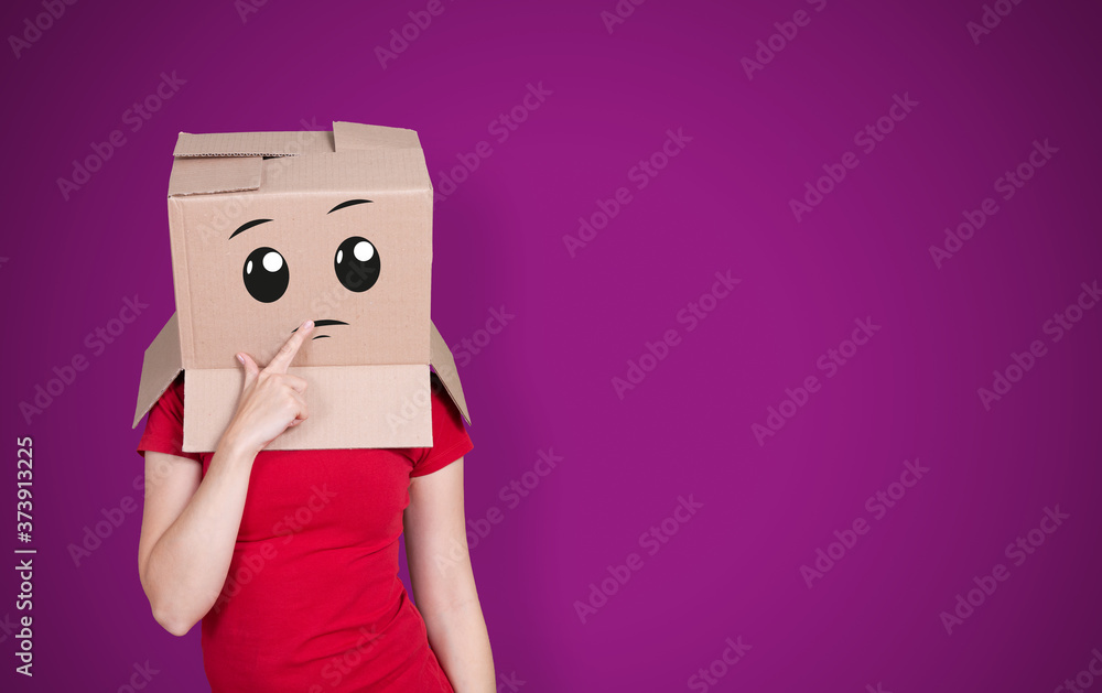 Person with cardboard box on its head and a thoughtful face expression on purple background