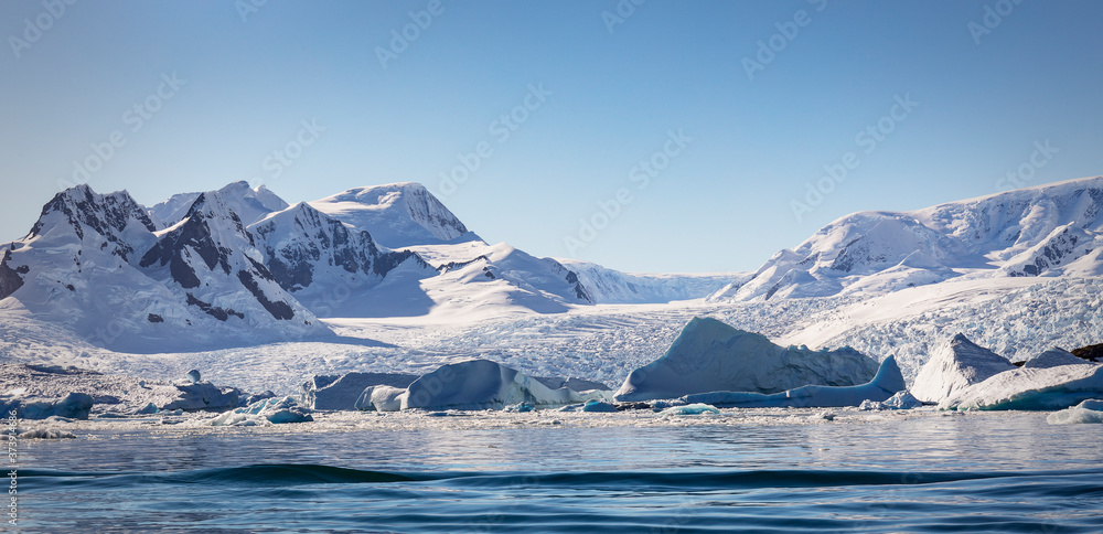 Icy mountains, icebergs and brash ice at Cierva Cove on the Antarctic Peninsula. Icy mountains, icebergs and brash ice at Cierva Cove on the Antarctic Peninsula.
