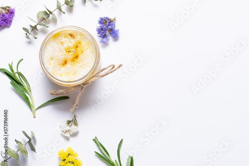 Organic homemade body scrub made with essential oils and herbs in white background with copy space for your text. Natural cosmetic concept. Home spa concept.