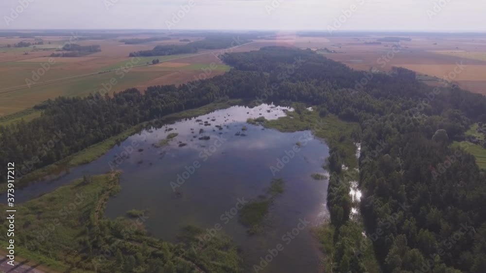 Solar Reflection In A Quarry Pond In The Middle Of The Forest. Aerial Arc Left Solar Reflection In A Quarry Pond In The Middle Of The Forest. Aerial Arc Left