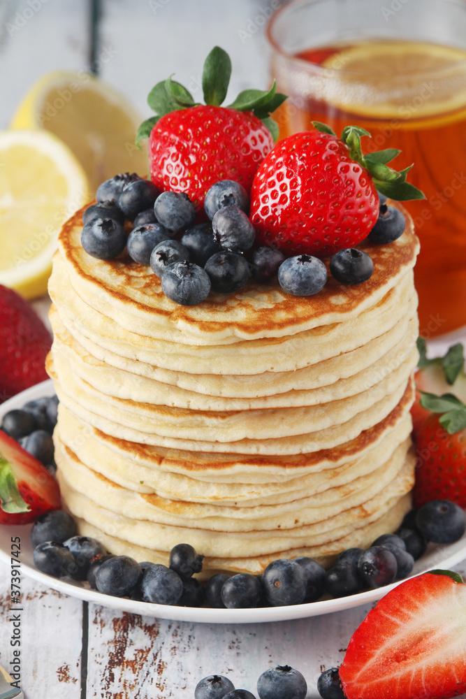 A stack if home-made pancakes with berry A stack if home-made pancakes with berry