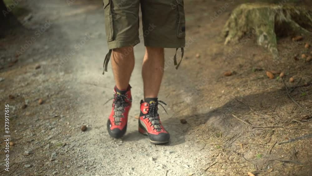 Slow motion shot of hiker with red hiking shoes Slow motion shot of hiker with red hiking shoes