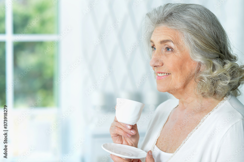 Close up portrait of beautiful smiling senior woman drinking tea Close up portrait of beautiful smiling senior woman drinking tea