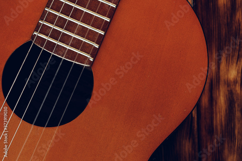 Wooden acoustic guitar body and fingerboard close up