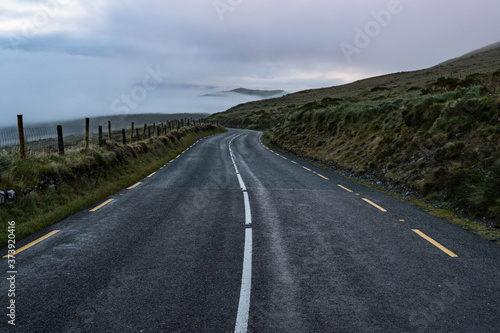 Empty roadway through the Dingle peninsula during misty