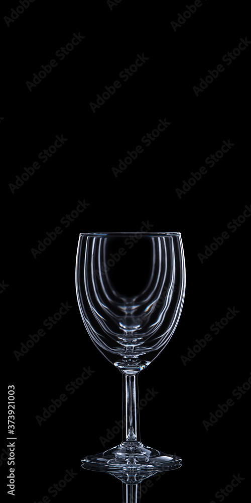 Wine glass on a black background with copy space. Wine collection harmony concept. Wine glass on a black background with copy space. Wine collection harmony concept.