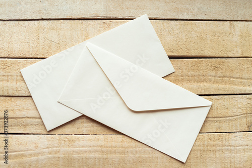 white envelopes on the wooden background