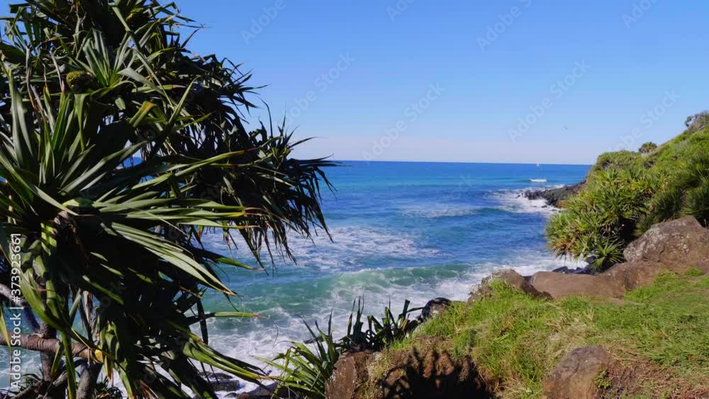 Blue Waves In The Ocean Splashing On The Rocky Coast - Burleigh Heads Beach - Gold Coast, Queensland, Australia. - wide shot Blue Waves In The Ocean Splashing On The Rocky Coast - Burleigh Heads Beach - Gold Coast, Queensland, Australia. - wide shot