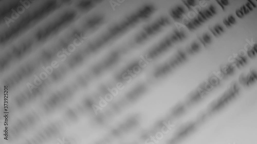 Turning pages of a book. Macro. Deails on words and phrases.