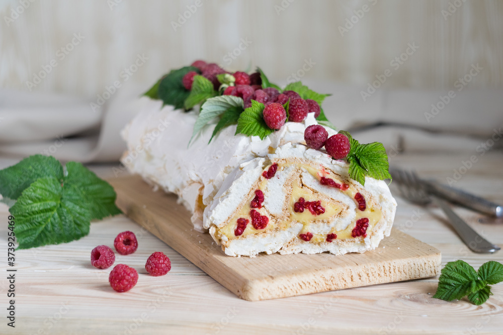 Meringue roll cake with cream and fresh raspberries. Roulade, summer dessert. Selective focus, horizontal orientation. Meringue roll cake with cream and fresh raspberries. Roulade, summer dessert. Selective focus, horizontal orientation.