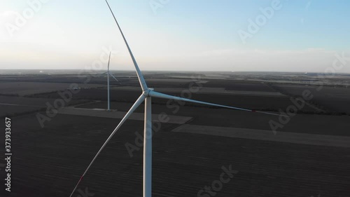 Damaged not rotating wind turbine power plant near sea. Windmill stopped broken. Aerial shot