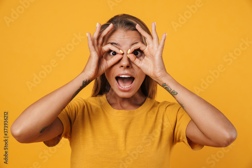 Image of nice amusing woman grimacing and showing ok sign gesture