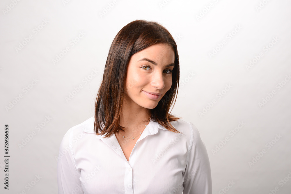 portrait of a beautiful young caucasian woman smiling and wearing a white shirt business dress on a white background portrait of a beautiful young caucasian woman smiling and wearing a white shirt business dress on a white background