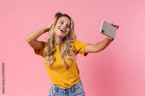 Optimistic woman taking a selfie by mobile phone