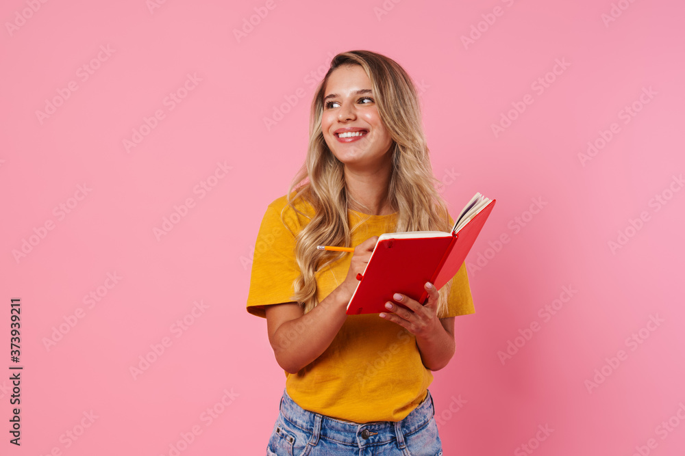 Happy woman writing notes in notebook Happy woman writing notes in notebook