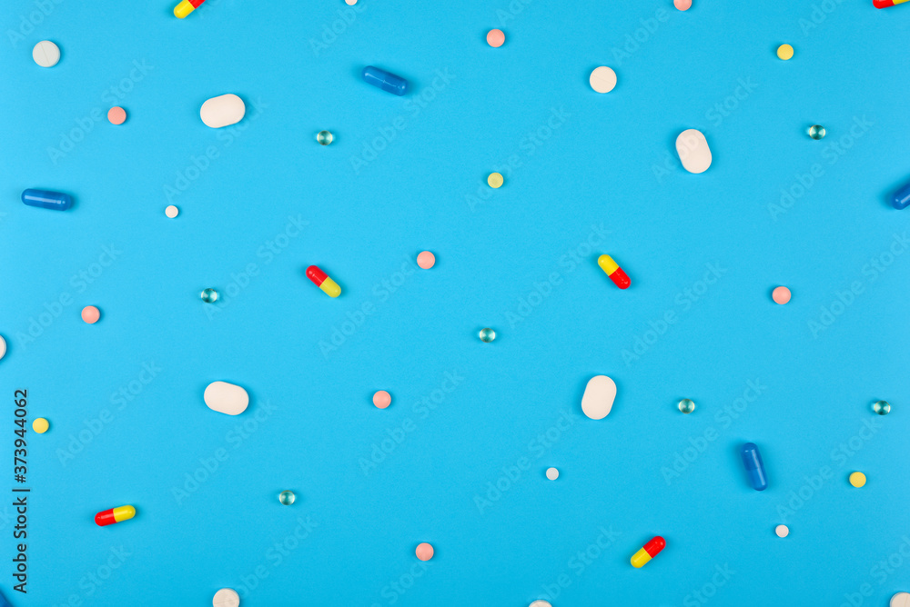 Pattern made from Various small Pills on bright blue background. Pattern made from Various small Pills on bright blue background.