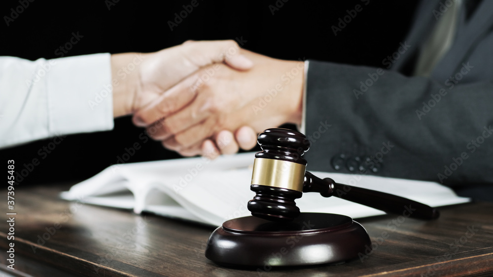 Lawyer consultant shaking hand with client in law firm. Lawyer consultant shaking hand with client in law firm.
