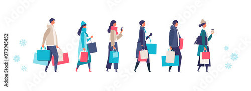 Some people carrying shopping bags at winter. Man and woman taking part in seasonal sale at store, shop, mall.