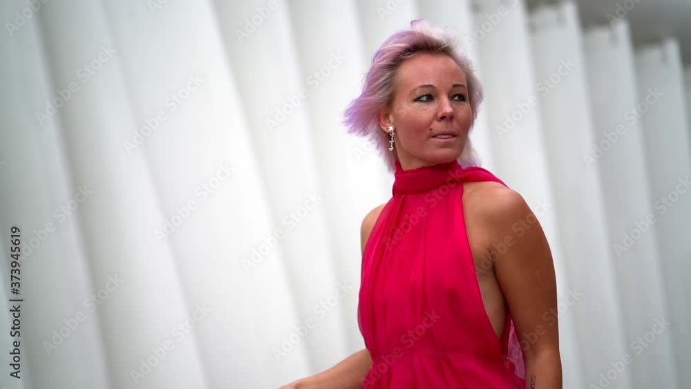 extravagant pink-haired woman in red dress is strolling at city, portrait extravagant pink-haired woman in red dress is strolling at city, portrait