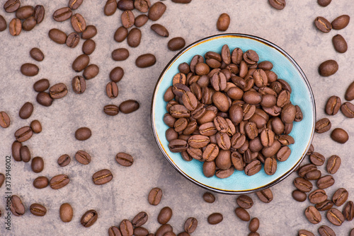 Roasted coffee beans on a textured background, empty copy space