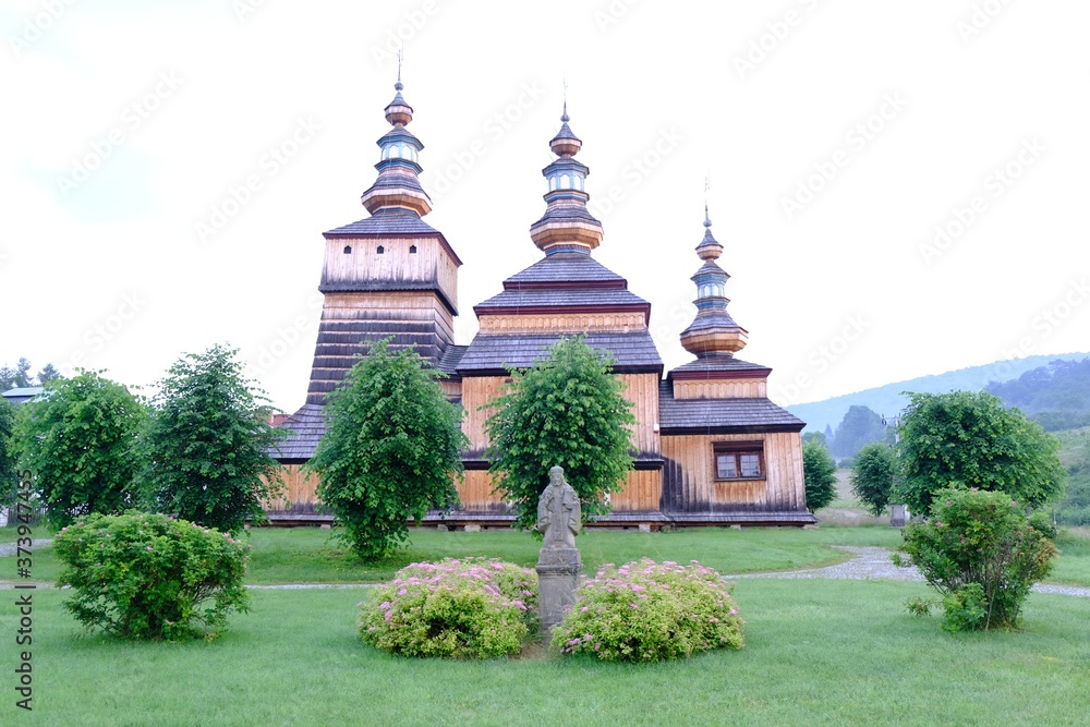 Beautiful historic wooden former lemko church in the village of Krempna on a sunny morning. Low Beskids Mountains, Poland