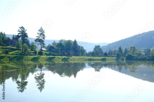 Beautiful view of Krempna reservoir on magical sunny morning. Reflections in the water. Low Beskids Mountains  Poland